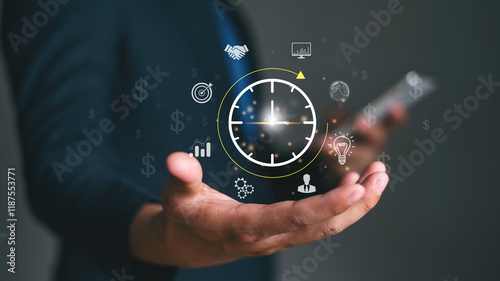 Man Planning time management increases efficiency and reduces work time and Project management concept. Businessman holding clock with icon business on interface virtual for time management.