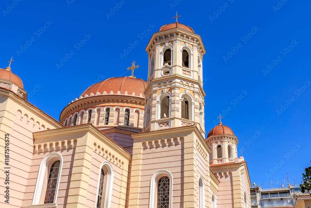 A large white and red building with a blue sky in the background A large white and red building with a blue sky in the background