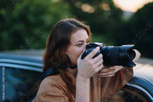 A young woman photographer capturing outdoor images with a DSLR camera, wearing a stylish brown shirt, showcasing creativity and passion for photography. photo