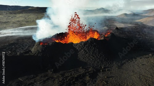 Volcano eruption, red hot burning lava erupts from ground, drone fly over active volcanic crater. Litli Hrutur Eruption 2023, Iceland. photo