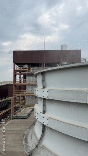 an industrial plant located in a city, featuring towering steel and concrete structures photo