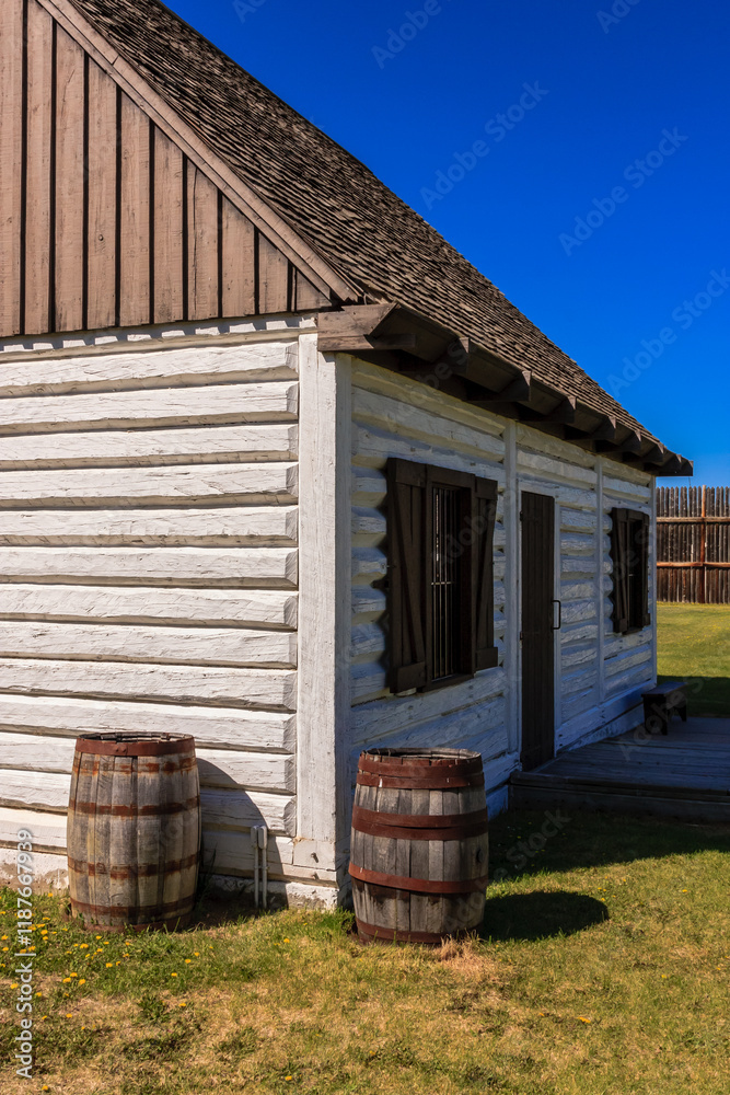 Obraz premium A white log cabin with a blue sky in the background