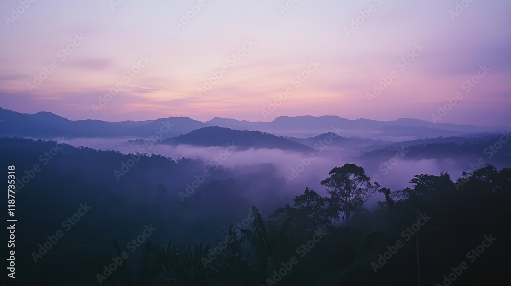 Naklejka premium Serene mountain landscape at dawn with misty valleys and purple sky