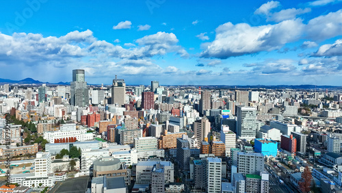 city, landscape, scenery, urban, town, society, drone, aerial view, blue sky, horizon, road, transportation, traffic, industry, business, infrastructure, bird eye view, high-angle, prospect, panorama,