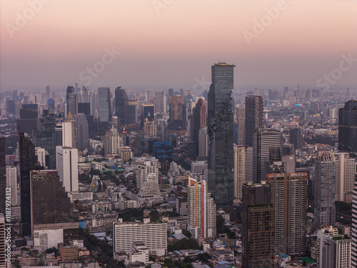 Bangkok high aerial view from the Chao Phraya River to Bang Rak and Si Lom districts at sunset. A large asian capital city with skyscrapers and millions of inhabitants. High quality panoramic photo