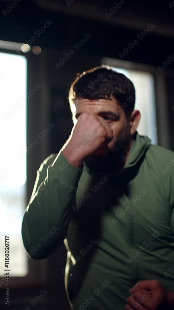 Professional boxer throwing powerful punches, training intensely with focused determination, preparing for fight inside dimly lit boxing gymnasium, showcasing athletic precision Professional boxer throwing powerful punches, training intensely with focused determination, preparing for fight inside dimly lit boxing gymnasium, showcasing athletic precision
