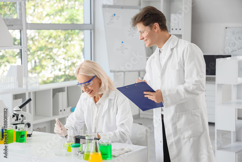Chemists with Petri dish wo...