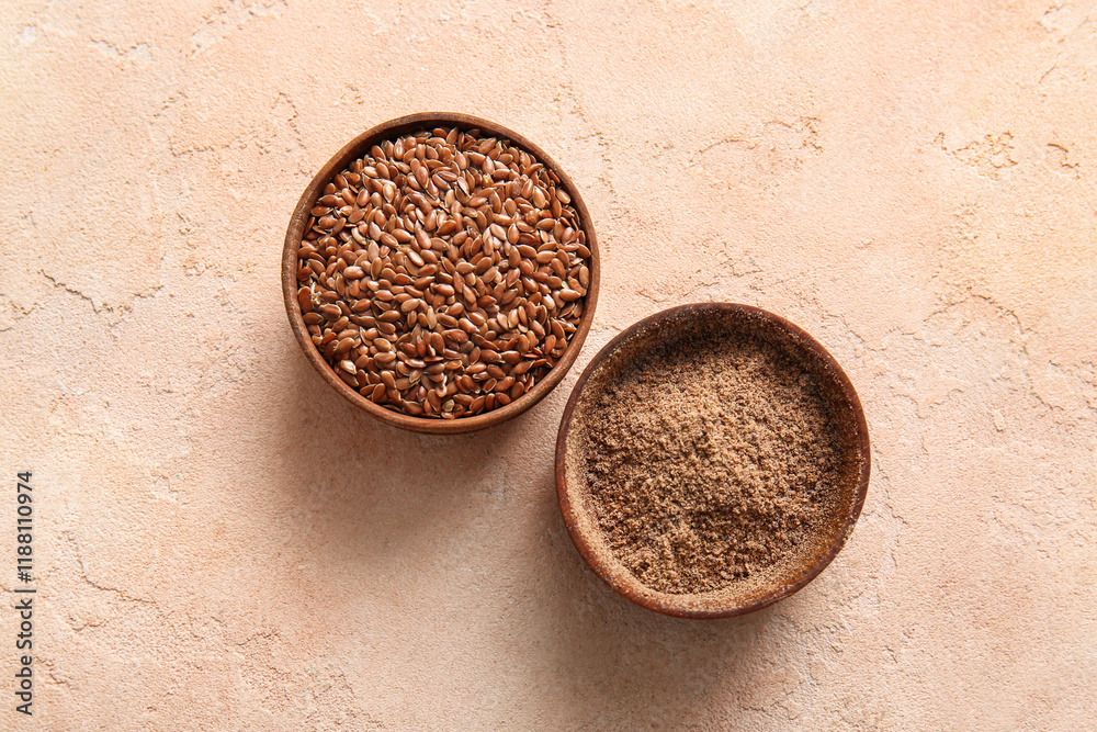 Wooden bowls of flax seeds and flour on beige background Wooden bowls of flax seeds and flour on beige background
