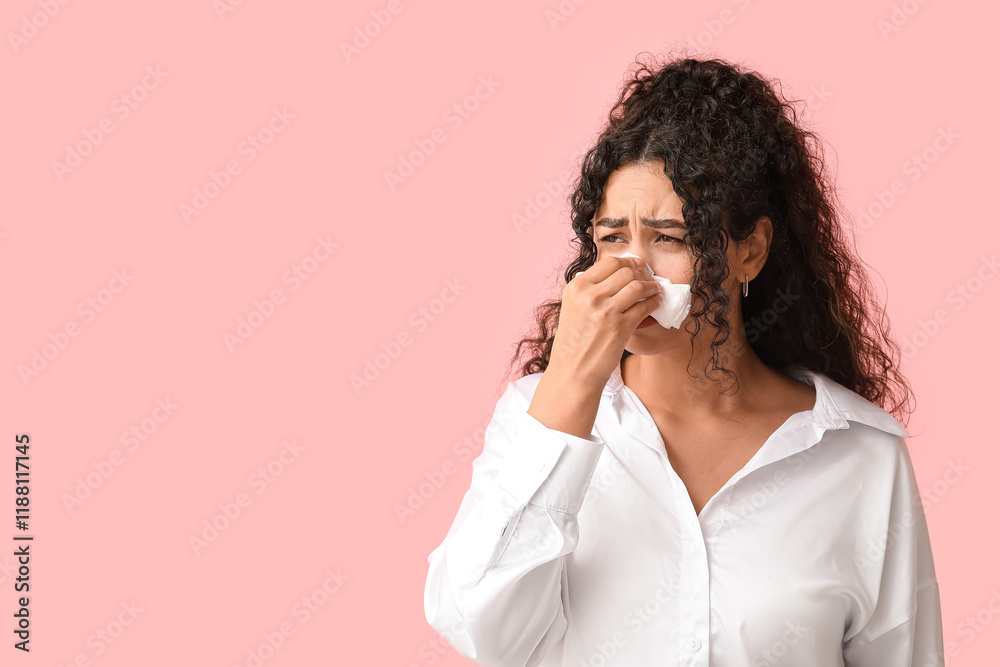 Young African-American woman with handkerchief suffering from allergy on pink background Young African-American woman with handkerchief suffering from allergy on pink background