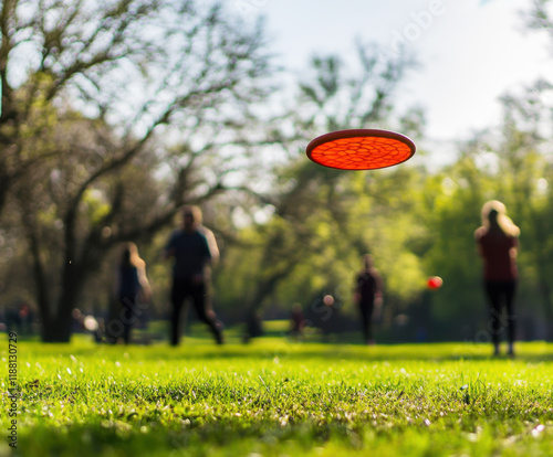 Frisbee flying through the air in a sunny park during an afternoon gathering of friends