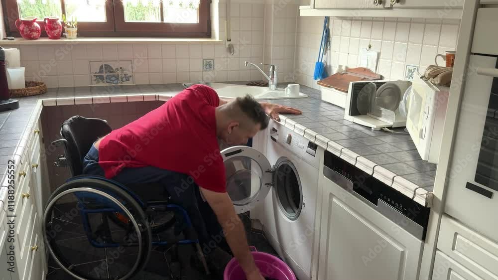 Strong man in a wheelchair fills the washing machine to wash laundry