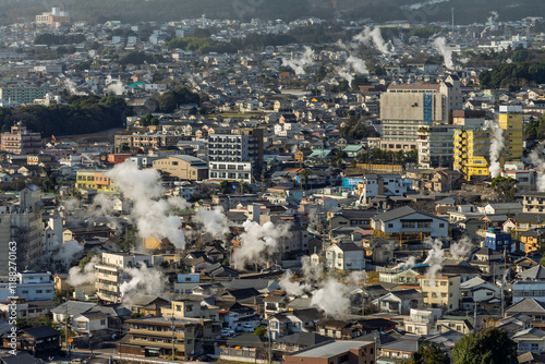 Beppu cityscape with Steam drifted from public hot spring baths and ryokan onsen background, Beppu, Oita, Kyushu, Japan. photo