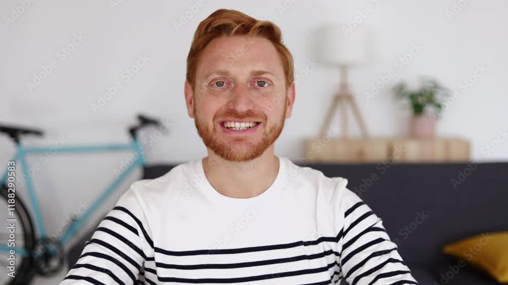 Video screen view of happy young man having an online conversation through video call from living room at home. POV male talking on web conference Video screen view of happy young man having an online conversation through video call from living room at home. POV male talking on web conference