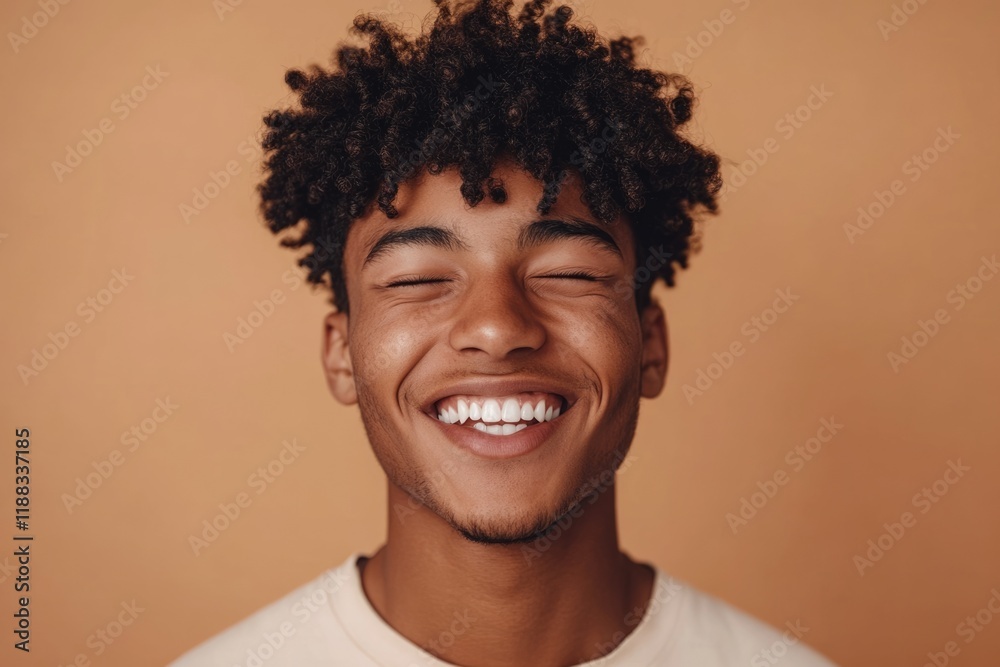 Smiling African American Gen Z guy winking in close up portrait. Smiling African American Gen Z guy winking in close up portrait.