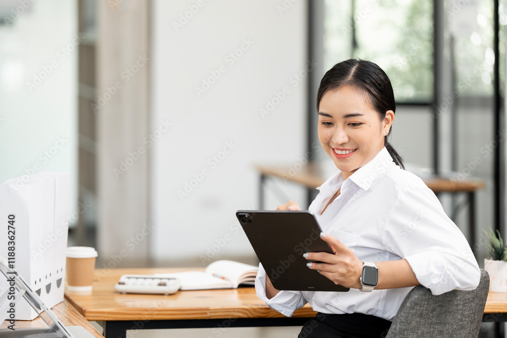 Successful business woman looking confident using digital tablet at desk office. Successful business woman looking confident using digital tablet at desk office.