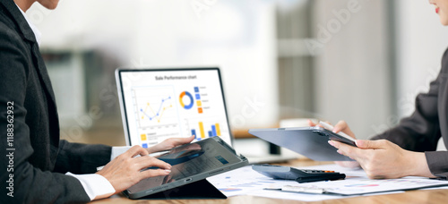 Two business woman coworkers working together in boardroom, brainstorming, discussing and analyzing and planning business strategy. photo