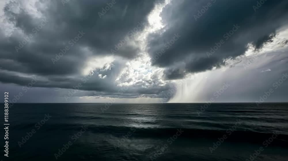 Dramatic ocean storm clouds rolling over dark waters with shimmering light
