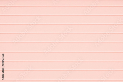 Pastel pink surface with corrugated cardboard like ribbed texture photo