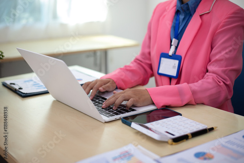 A group of business professionals engaged in a discussion to collaborate on an important project. The atmosphere reflects professionalism, with documents, graphs, and statistical data showcasing avera photo