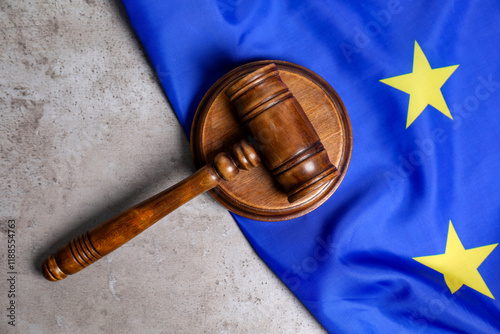 Judge's gavel and flag of European Union on grey table, top view photo