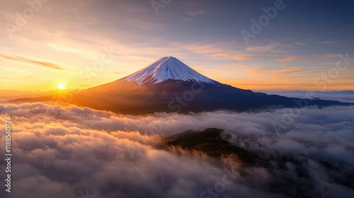 A view of a mountain covered in clouds at sunset