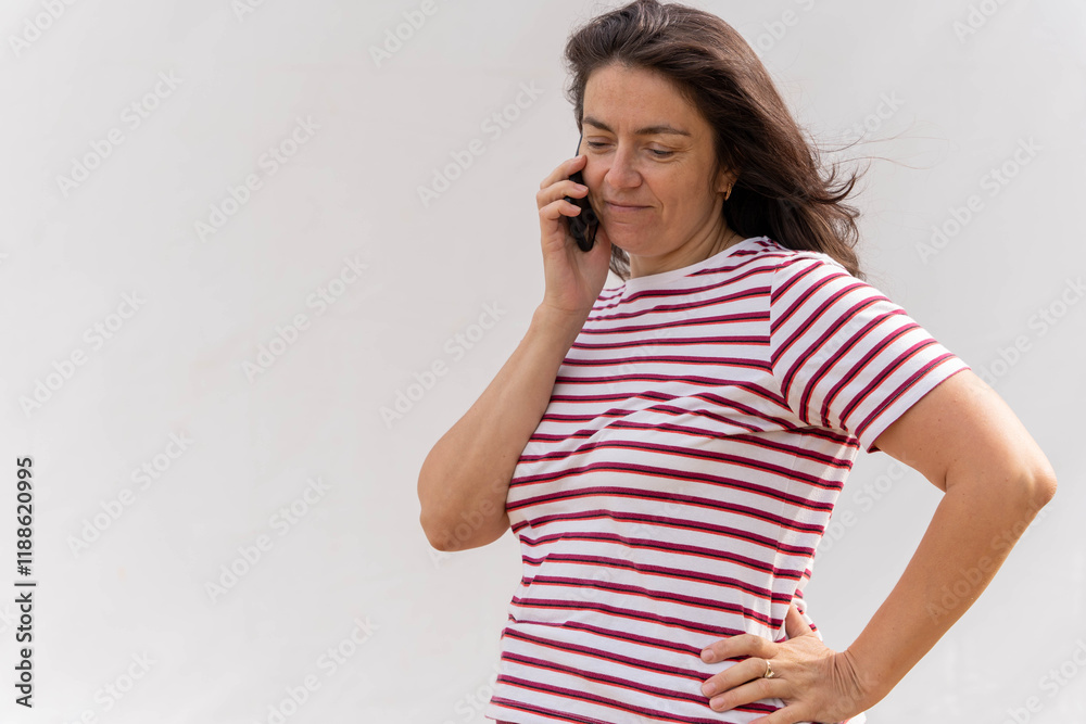 middle-aged Caucasian woman with long hair talking on mobile phone middle-aged Caucasian woman with long hair talking on mobile phone
