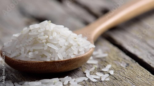 Rice in a wooden spoon on the table