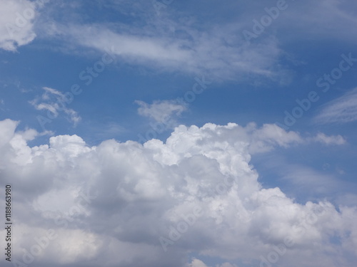 Clouds billow across the brilliant blue summer sky like cotton tufts, billowing, puffy, soft, the sky is bright blue and the clouds are white. The sky during the day has pure white clouds like cotton photo