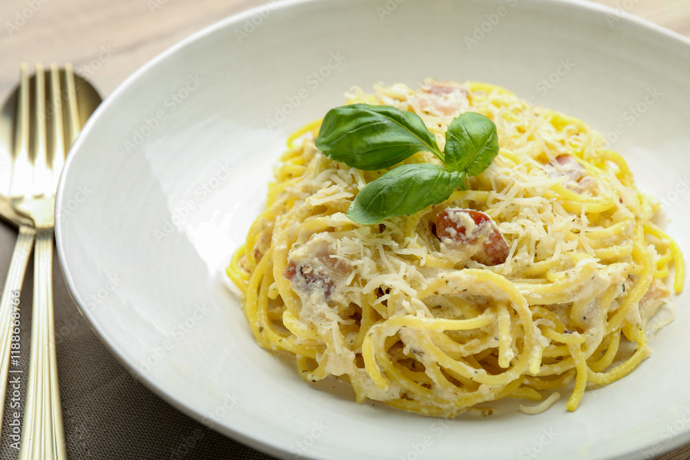 Delicious pasta Carbonara with basil on table, closeup Delicious pasta Carbonara with basil on table, closeup