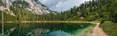 Panoramic view at lake Ahornsee in European Alps mountain, Styria, Austria. Landscape natural scenery and reflection of rock mountains and forest at water surface photo