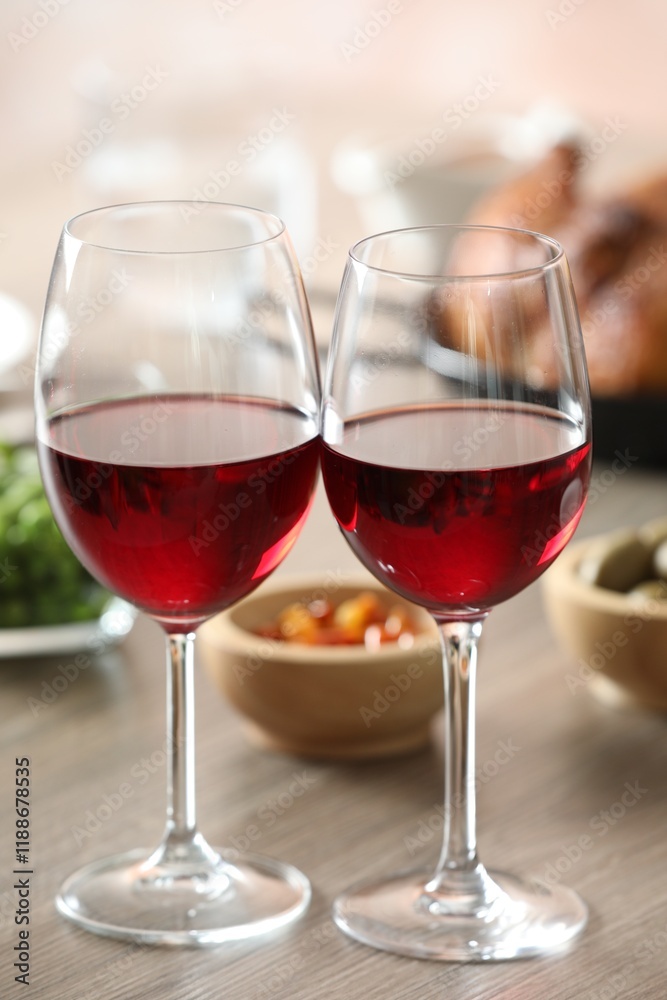 Red wine and delicious dinner served on wooden table, closeup Red wine and delicious dinner served on wooden table, closeup