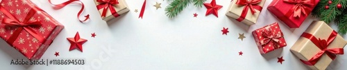 A variety of wrapped Christmas gifts on a plain white surface with some wrapping paper and ribbons visible, holiday items, wrapping paper