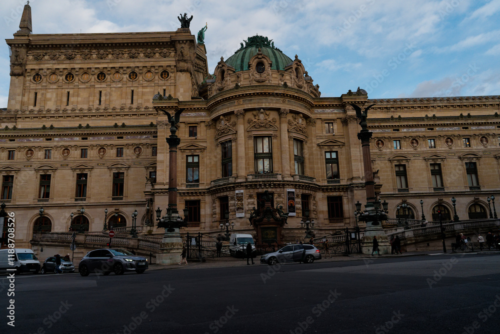 Historic building with ornate architecture and statues during early evening in a bustling city center Historic building with ornate architecture and statues during early evening in a bustling city center