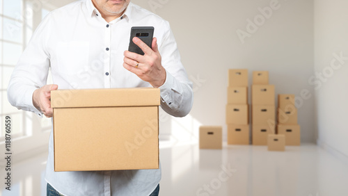 Man with boxes in empty roo...