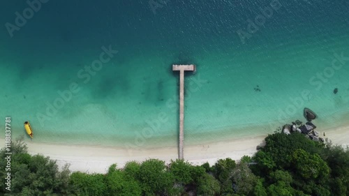 Aerial footage of a wooden pier on a sandy beach on a sunny day in the Perhentian Islands, Malaysia photo