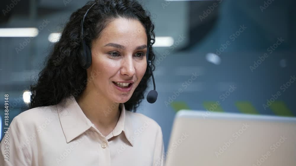 Female corporate operator in wireless headset working in customer support service on helpline telesale talking using laptop sitting in business office. Agent of call center advises client. Close up