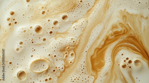 High-angle full-frame shot of coffee and milk swirling together, featuring frothy foam bubbles and creating a captivating abstract pattern. Perfect for food and beverage backgrounds.