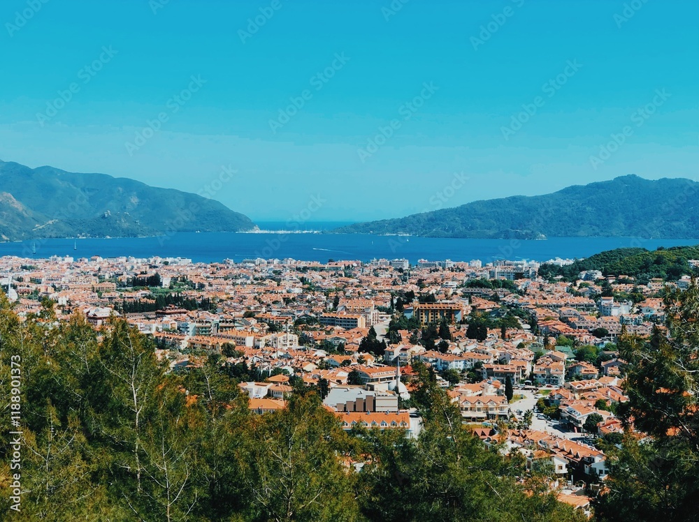 Fototapeta premium A tranquil Turkish seaside village, sheltered by majestic mountains.