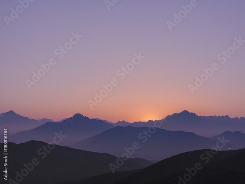 a serene and minimalistic sunset over a silhouette of distant mountains.