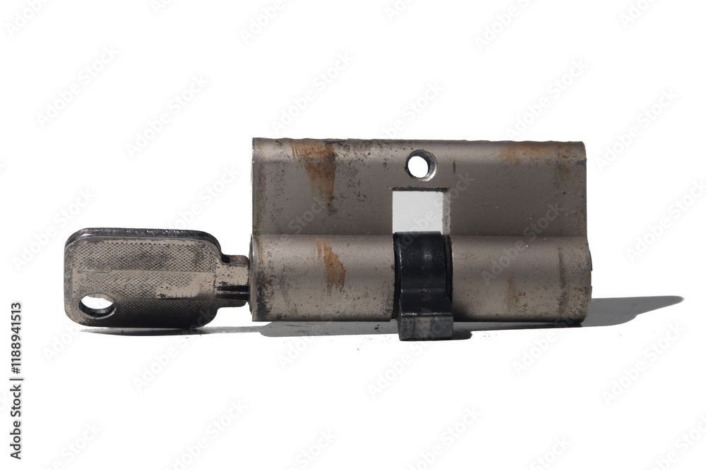 Used door lock cylinder with key on white background Used door lock cylinder with key on white background
