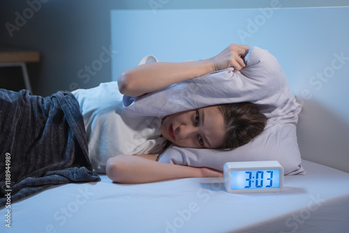 Asian women opened eyes lying on the bed have an insomnia problems.