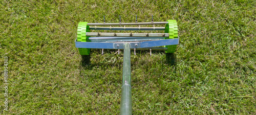 Rolling lawn aerator lawn in action