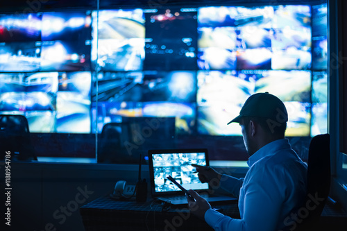 Security guards are monitoring multiple CCTV monitors and reporting on events that occur.