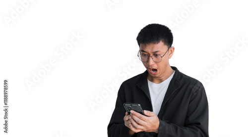 Young Asian man wearing black coat is excited and surprised by notification on his cell phone, isolated on white background. Man is surprised by message he received on his smartphone. Shock face