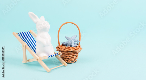 Bunny or rabbit sitting on lounge chair, basket with sea stars, easter holiday, vacation by the sea photo