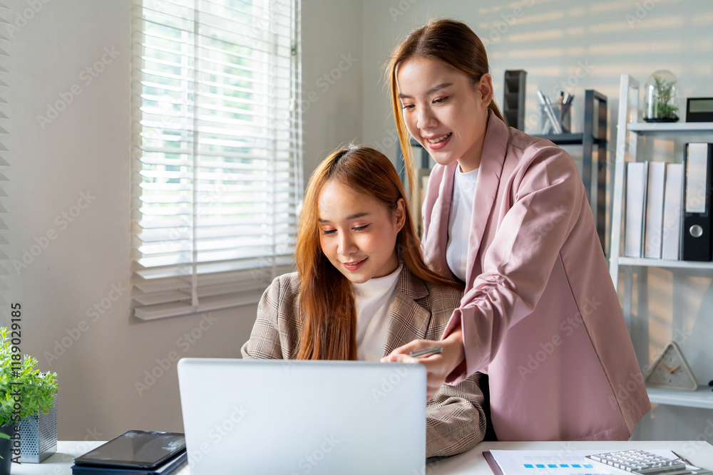 Businesswoman sitting at desk on couch in workplace or at home working on laptop and analyzing data on charts and graphs and writing on papers to make business plan and strategies for company. Businesswoman sitting at desk on couch in workplace or at home working on laptop and analyzing data on charts and graphs and writing on papers to make business plan and strategies for company.