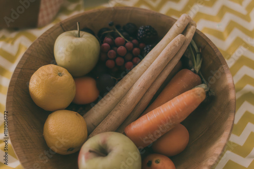Rustic Fruit and Vegetable Bowl with Apples, Citrus, and Carrots on Patterned Tablecloth