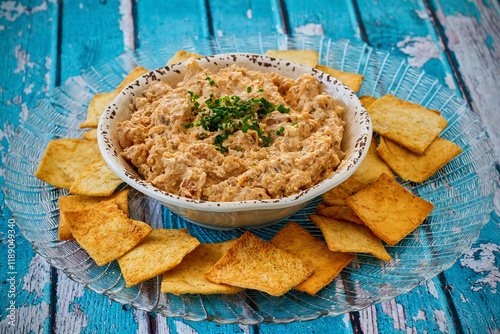spicy crab dip in al light blue bowl served with pita toast points