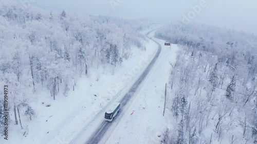 Snowy forest road reveals stunning aerial views of winter landscape in remote area