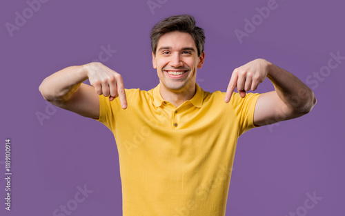 Blogger man pointing down advertising area. Violet background. Click, subscribe